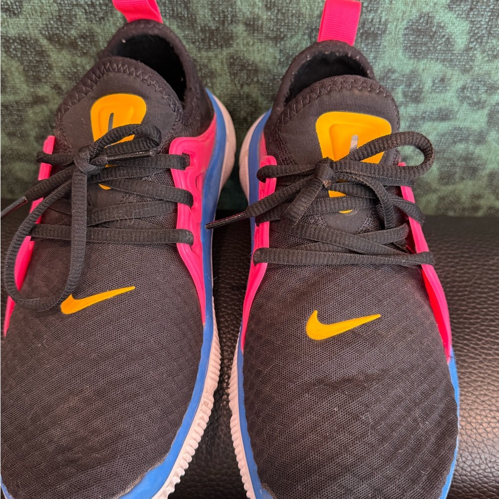 Black and Pink Nike Athletic Shoes with Yellow/Orange and Blue Accents
